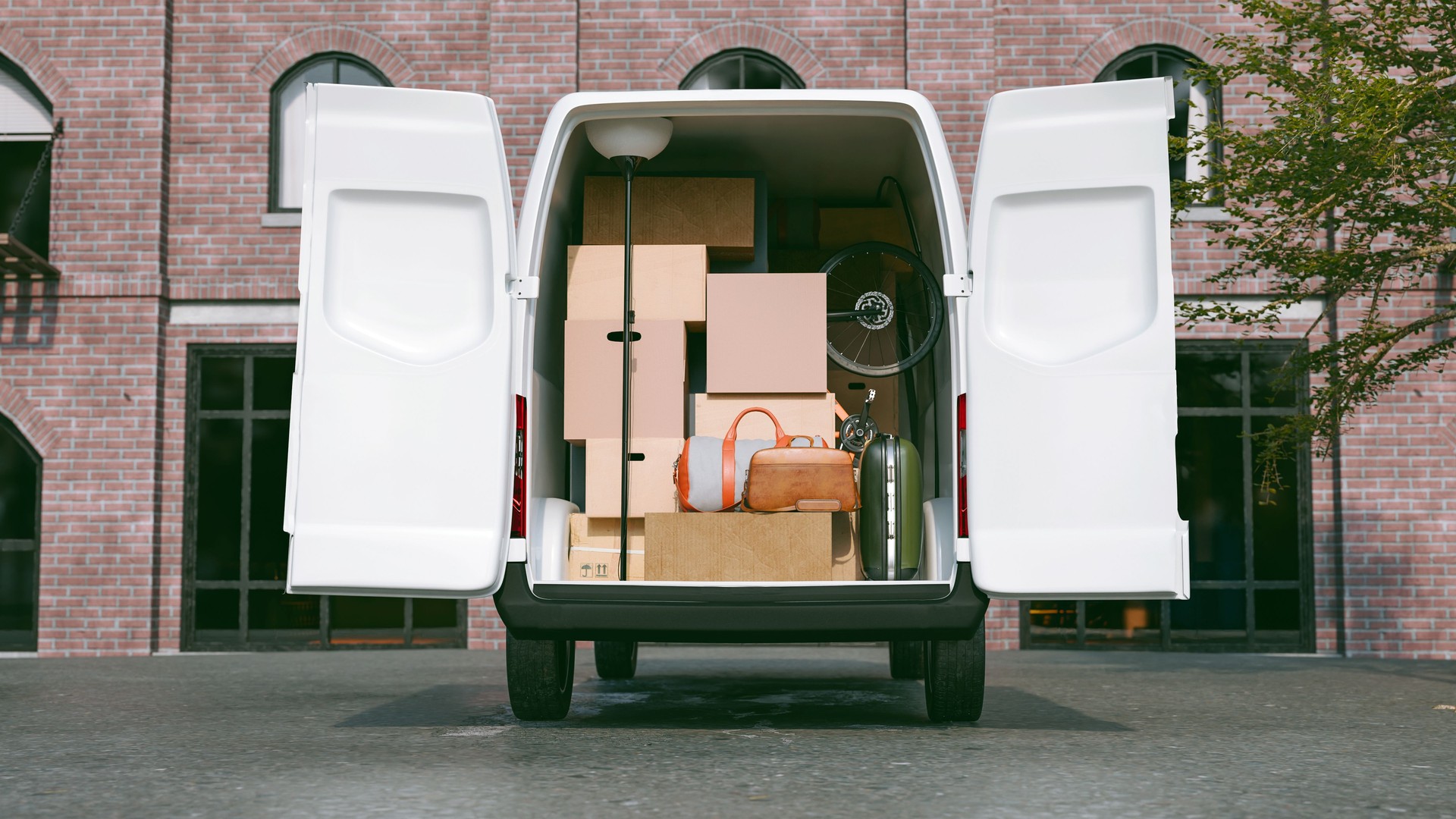 Moving van full of cardboard boxes parked outside a building